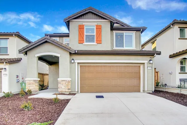 a front view of a house with a yard and garage