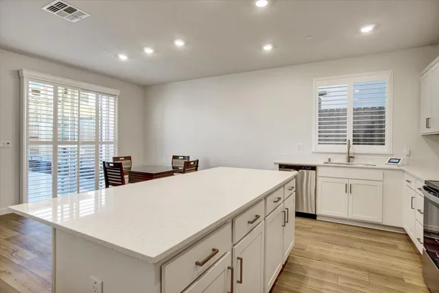 a kitchen with granite countertop a sink and wooden cabinets