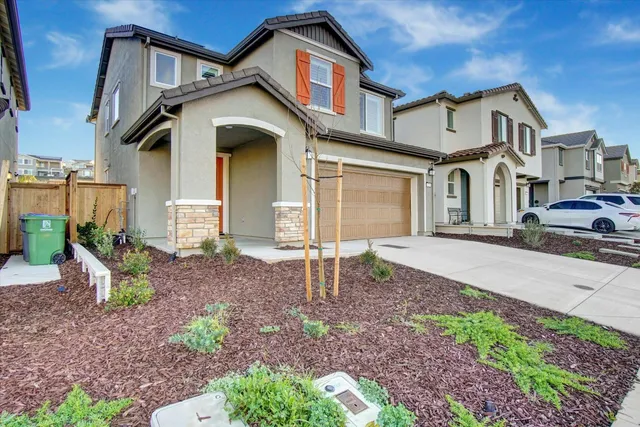 a front view of a house with garden