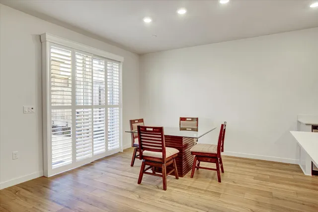 a dining room with furniture and wooden floor