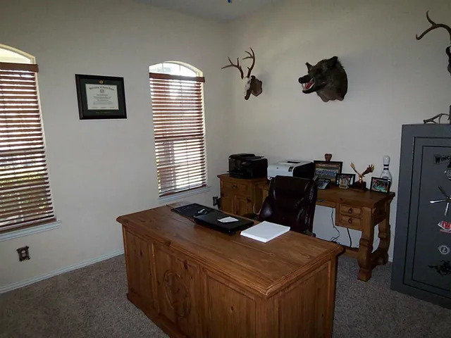 a view of a workspace with furniture