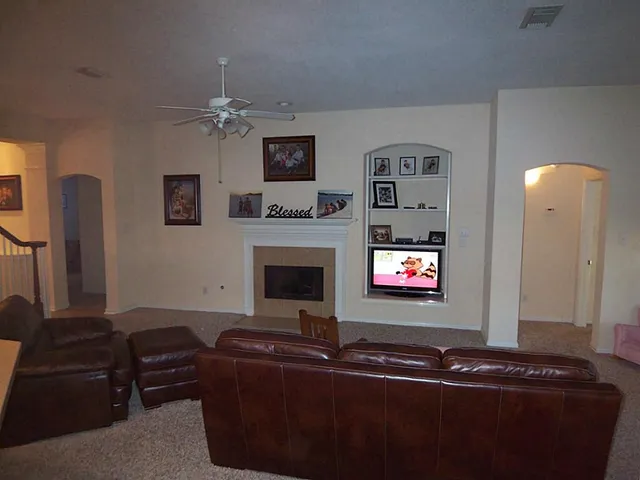 a living room with furniture a fireplace and a flat screen tv