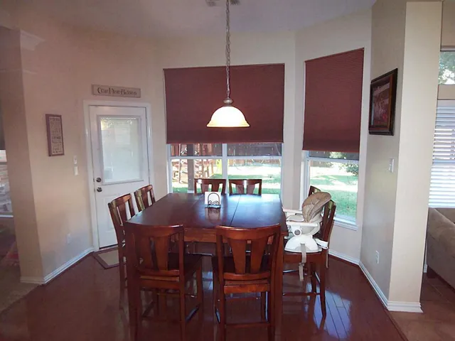 a dining room with furniture and window