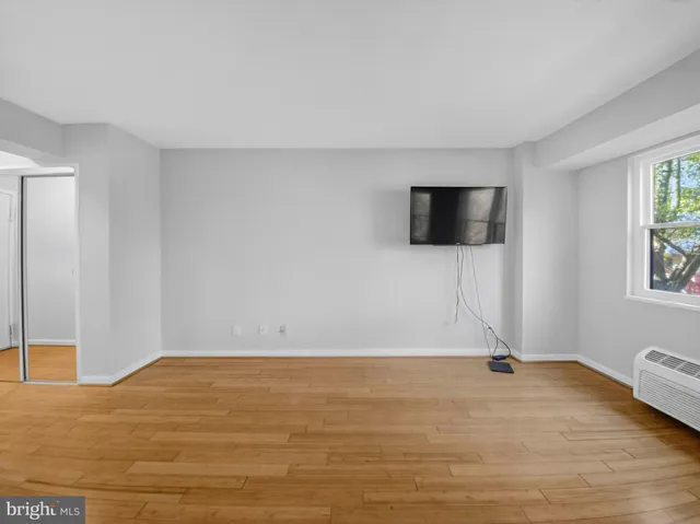 a view of a livingroom with wooden floor and a flat screen tv