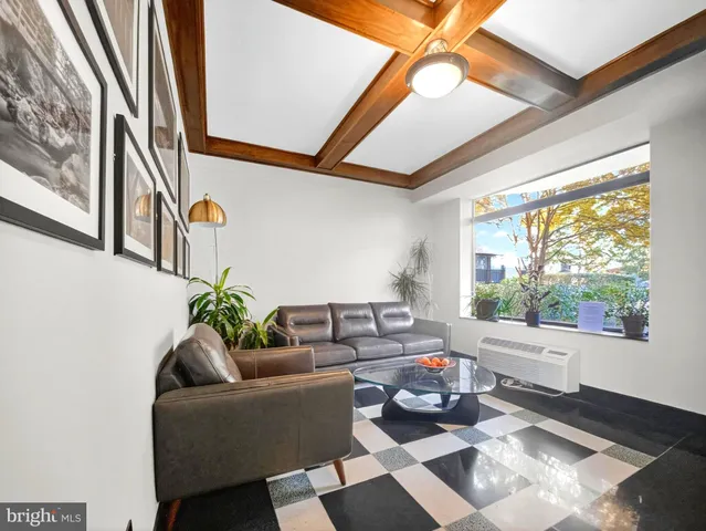 a living room with furniture and a large window with garden view