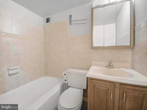 a bathroom with a sink a toilet and bathtub
