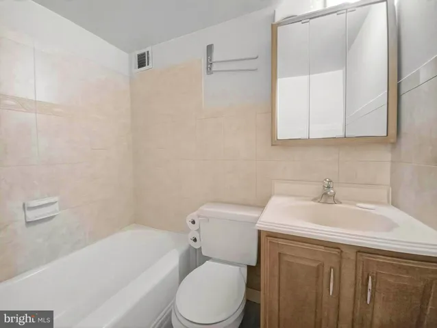 a bathroom with a sink a toilet and bathtub