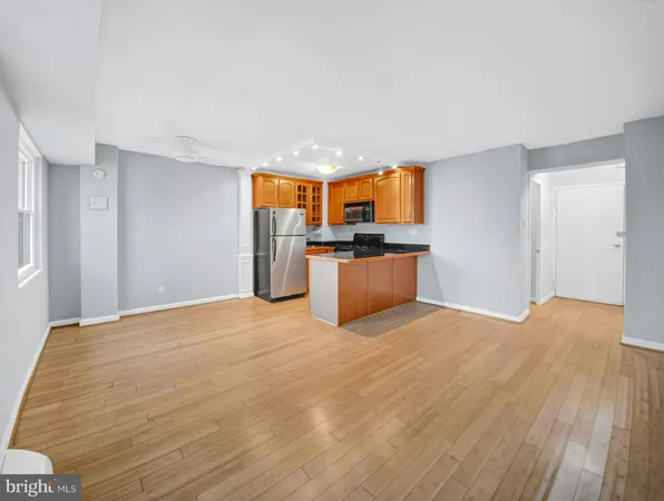 a view of a kitchen with a sink and a refrigerator