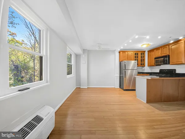 a view of kitchen with stainless steel appliances granite countertop a refrigerator and a stove top oven