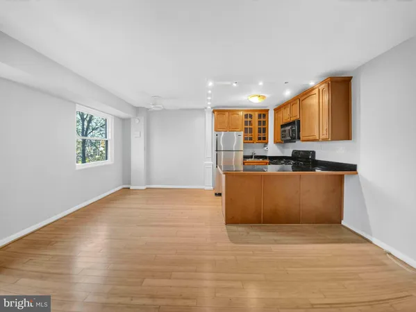 a view of kitchen with stainless steel appliances granite countertop a stove a sink and a refrigerator