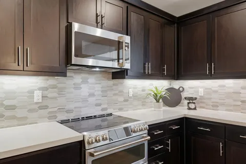 a kitchen with a sink stove and microwave
