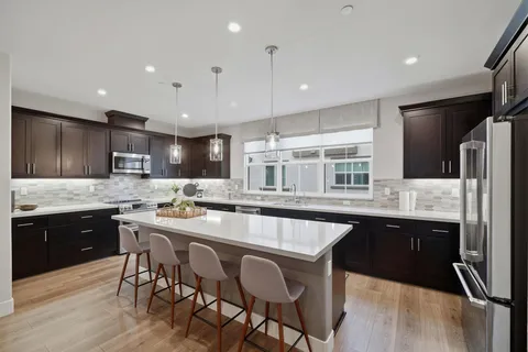 a kitchen with granite countertop a sink and appliances