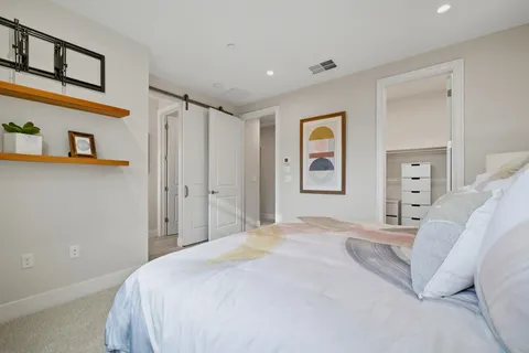 a bedroom with a large bed and a window