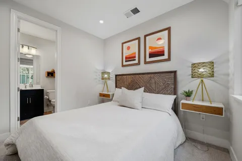 a bedroom with a bed and a lamp