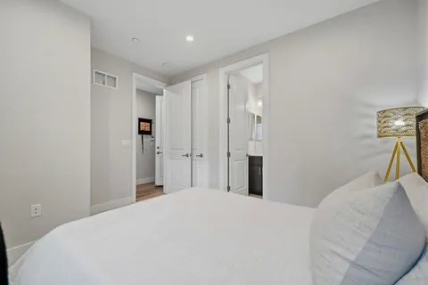 a bedroom with a bed and a lamp