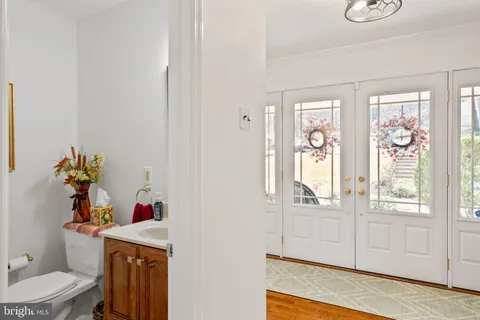 a living room with furniture a flat screen tv and a window
