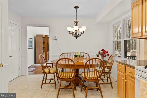 a view of a patio with table and chairs with wooden floor and fence