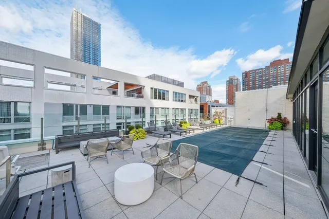 a kitchen with stainless steel appliances a stove and wooden floor