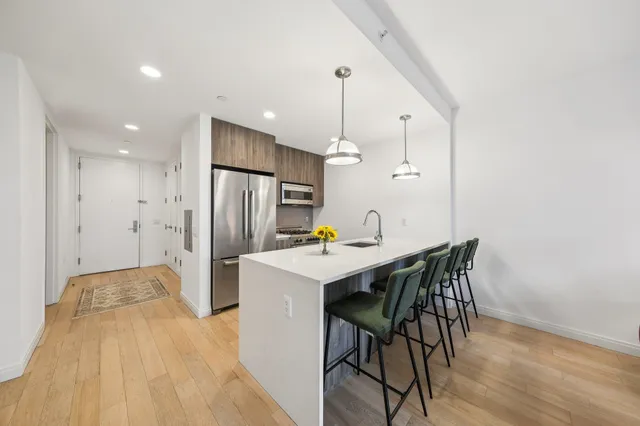 a kitchen with stainless steel appliances a refrigerator and a table