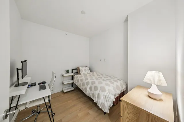 a bedroom with a bed and a table in it