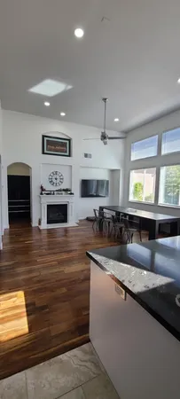 a view of a backyard with potted plants and a bench
