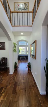 a living room with furniture a chandelier and a flat screen tv