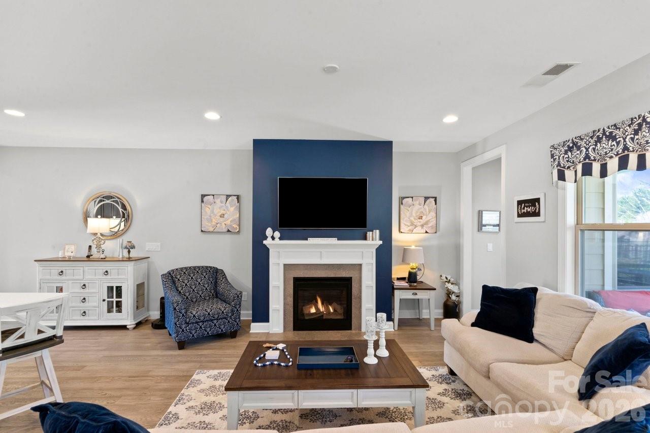 4979 Looking Glass Trail Denver, NC 28037 - Photo 20 of 46 a living room with furniture a flat screen tv and a fireplace