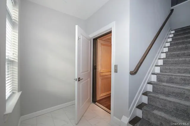a view of entryway with wooden floor and stairs