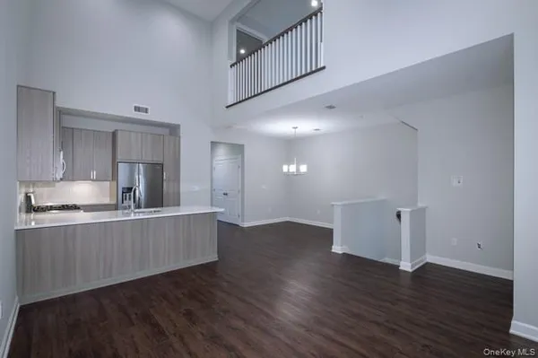 a kitchen with stainless steel appliances granite countertop a wooden floors