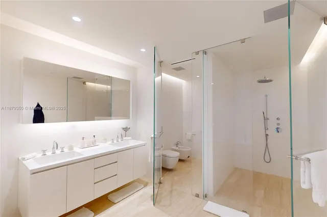 a en suite bathroom with a double vanity sink a mirror and a shower