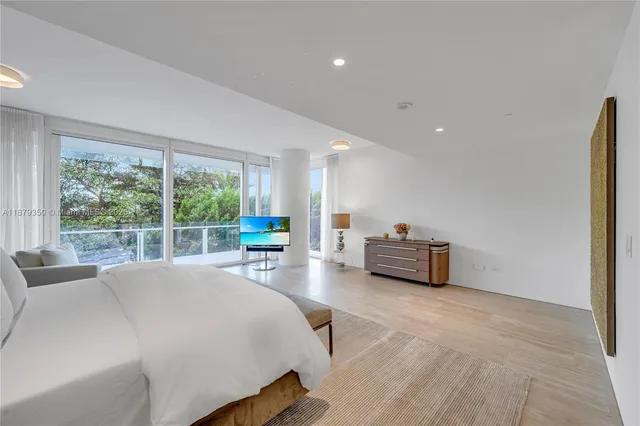 a bed room with a bed and a large window