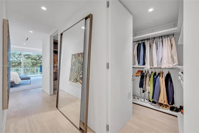 a view of walk in closet with clothes and shoes