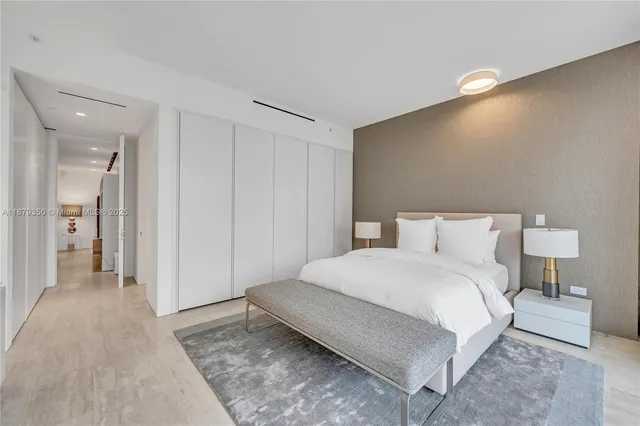 a bedroom with a bed and a lamp