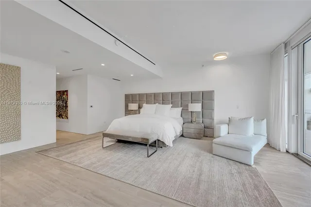 a spacious bedroom with a bed and a couch