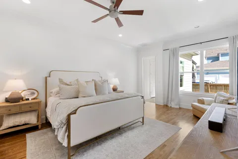 a living room with a bed furniture and a flat screen tv