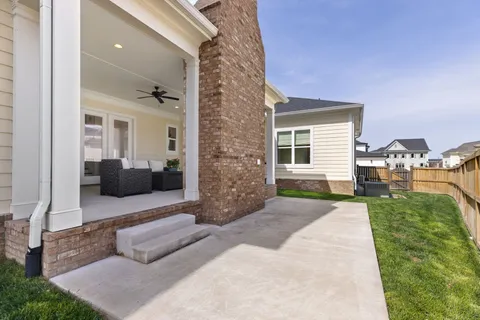 a bathroom with a granite countertop sink a toilet and a mirror