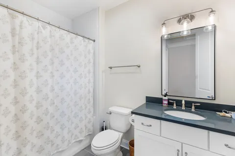 a bedroom with a bed and a book shelf