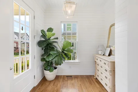 a view of a potted plant in a room with a window