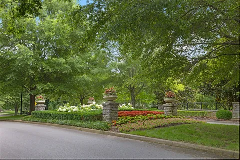 a view of a lake with a house and a big yard