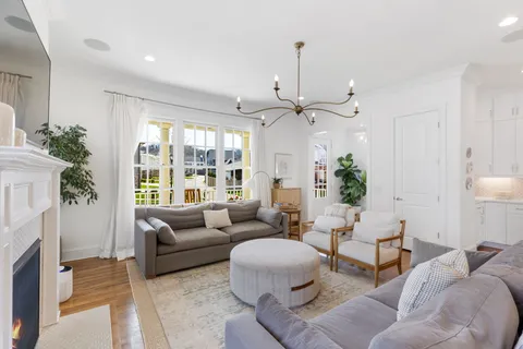 a living room with furniture and a chandelier