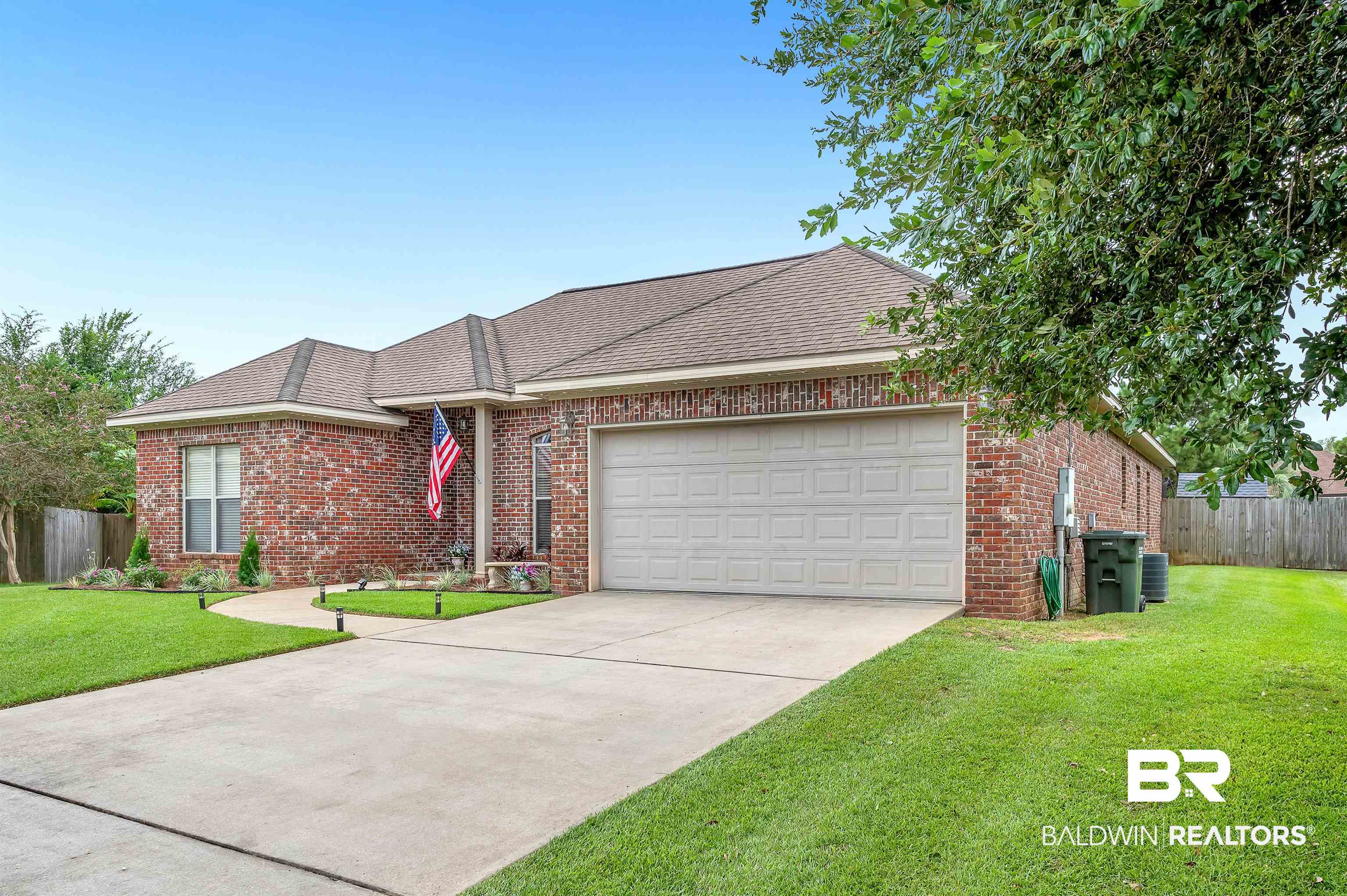 9376 Sable Court Daphne, AL 36526 - Photo 41 of 46 Ranch-style home with central air condition unit, a garage, and a front yard