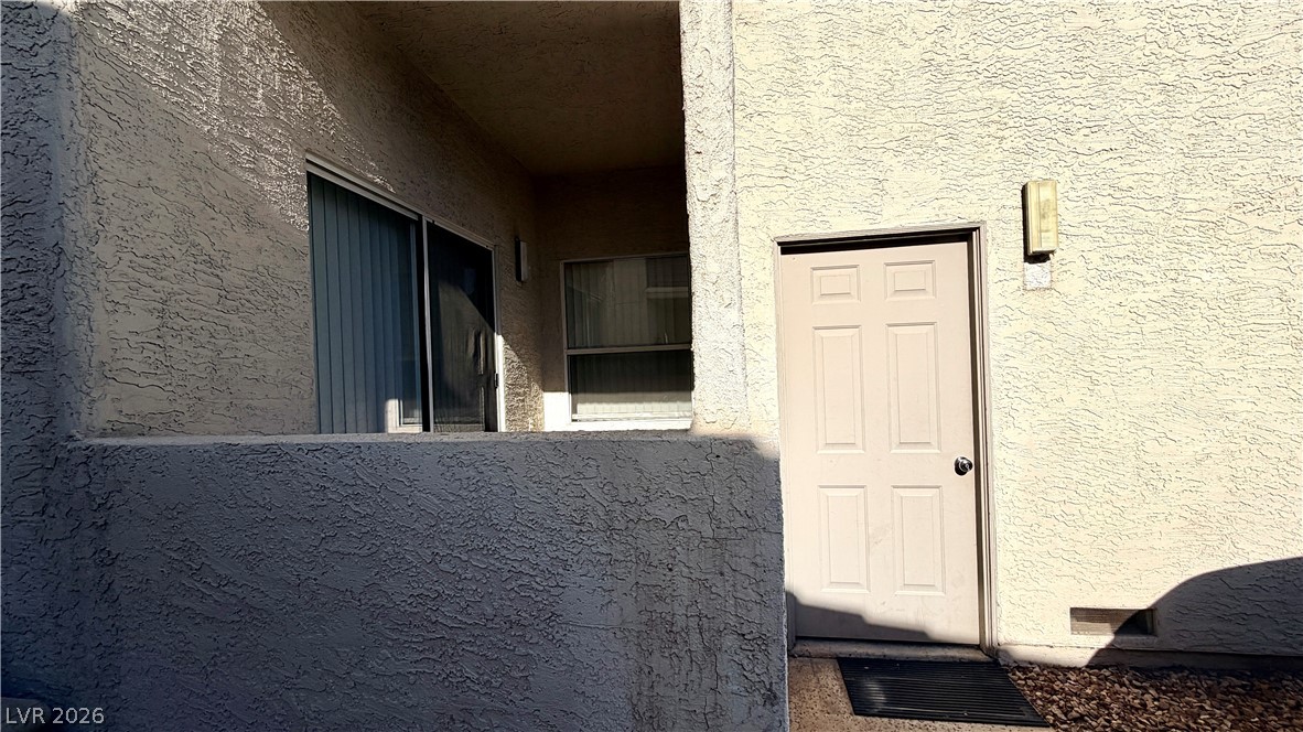 6250 West Flamingo Road, Unit 4 Las Vegas, NV 89103 - Photo 3 of 45 This outdoor view showcases the building's exterior with textured walls.