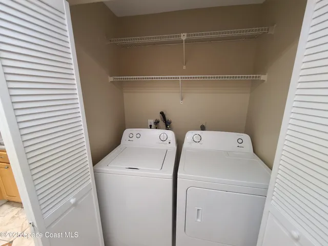 a view of an empty room and a ceiling fan