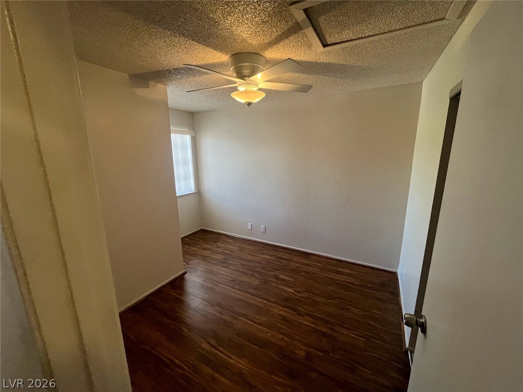 914 Scarlet Ridge Drive Las Vegas, NV 89128 - Photo 19 of 25 Rich hardwood-style flooring and a ceiling fan create a comfortable, inviting atmosphere.
