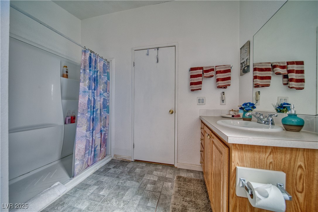 2891 Rio Rico Drive Pahrump, NV 89048 - Photo 13 of 45 Bathroom featuring a stall shower and vanity