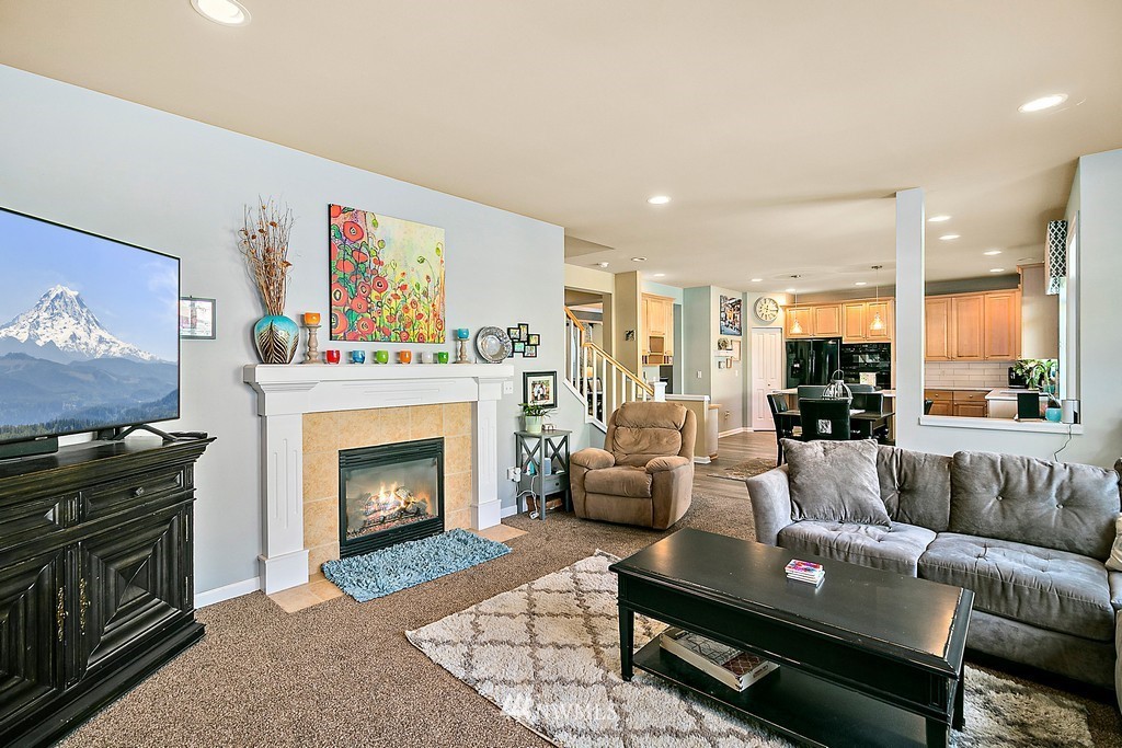 16718 Southeast 165th Way Renton, WA 98058 - Photo 22 of 40 a living room with furniture and a fireplace