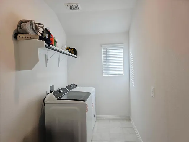 a view of storage and utility room with washer and dryer