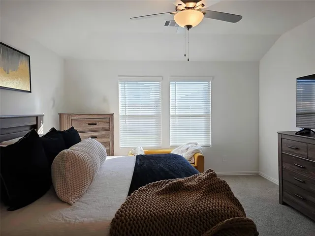 a bedroom with bed and window