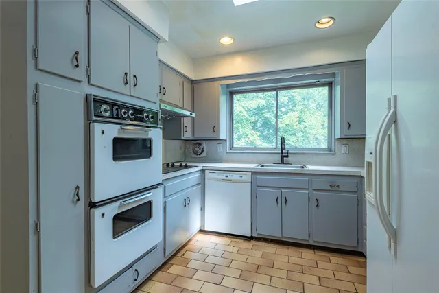 a kitchen with a stove sink and refrigerator