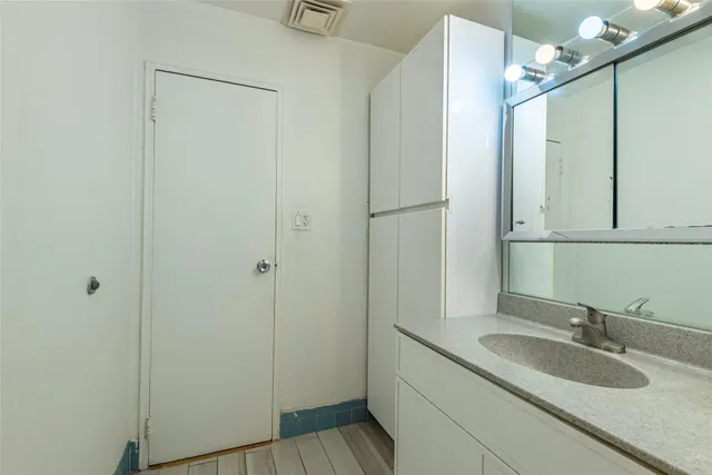 a bathroom with a sink and mirror